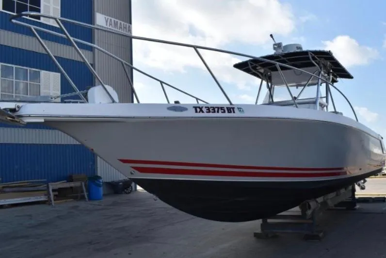 Slide: The Image of 2001 Pro-Line 3400 Bimini Cuddy boat on dock, side view with registration number. - 4