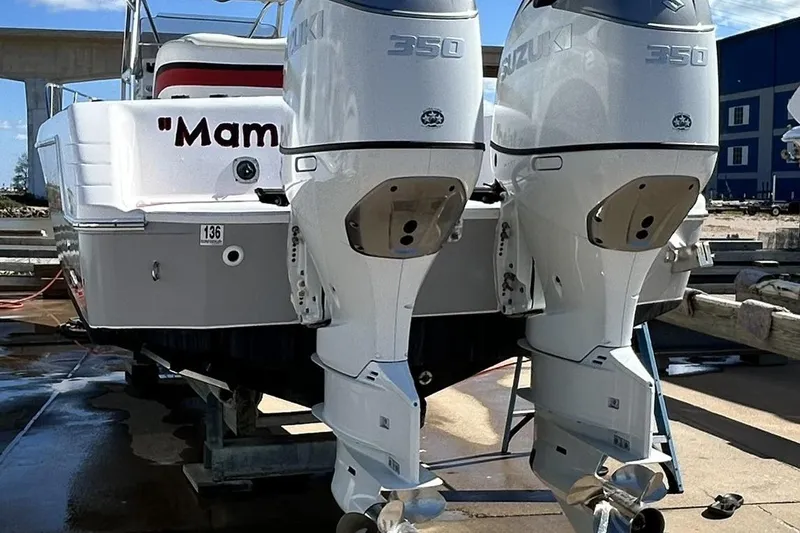 Slide: The Image of 2001 Pro-Line 3400 Bimini Cuddy boat with twin Suzuki 350 engines. - 8