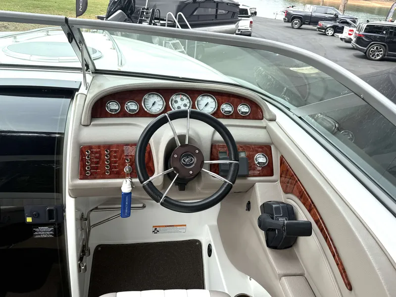 Slide: The Image of Interior view of a 2006 Cobalt 263 boat cockpit with wood trim. - 10