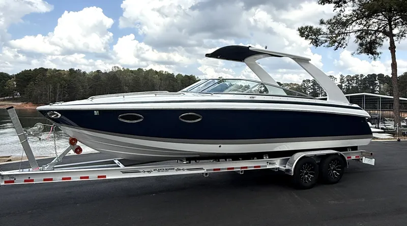 Slide: The Image of 2006 Cobalt 263 boat on trailer near lake and forest. - 4