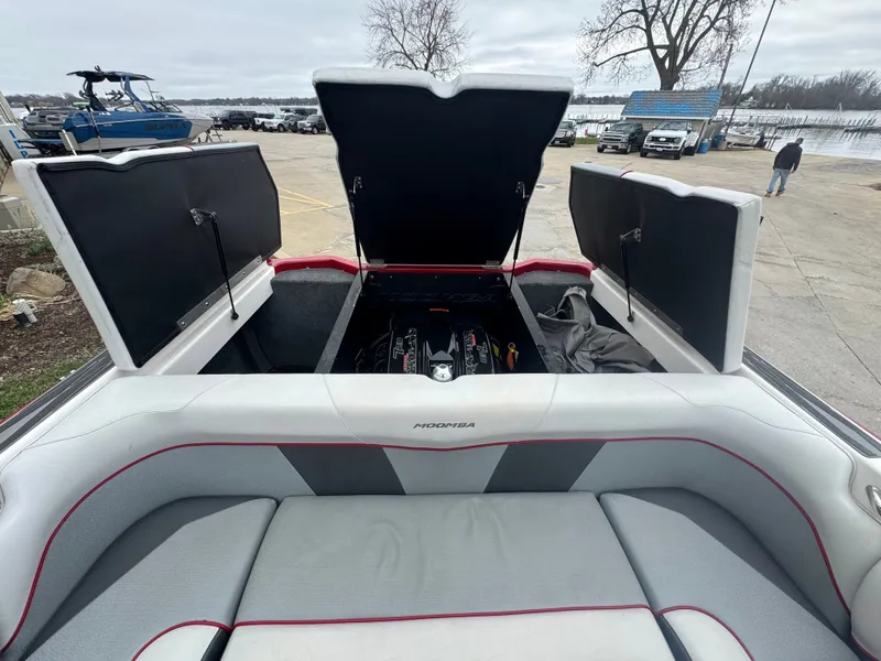 Slide: The Image of 2017 Moomba Mondo boat with open engine compartment at the dock. - 20