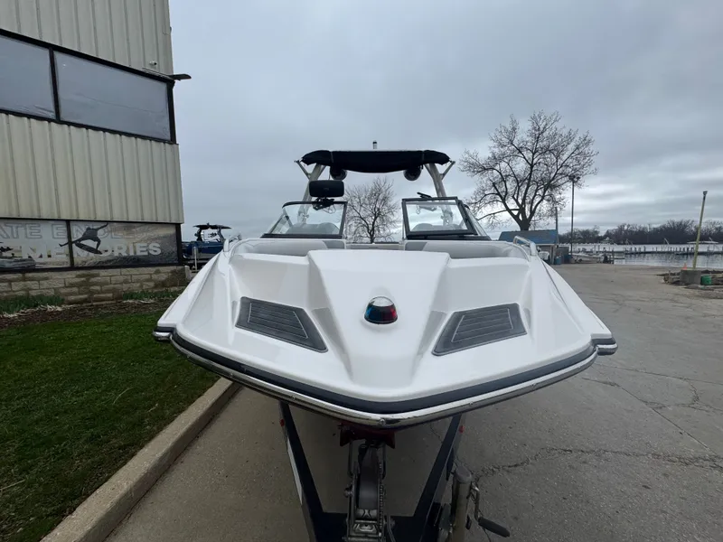 Slide: The Image of 2017 Moomba Mondo boat on a trailer in front of a building. - 7