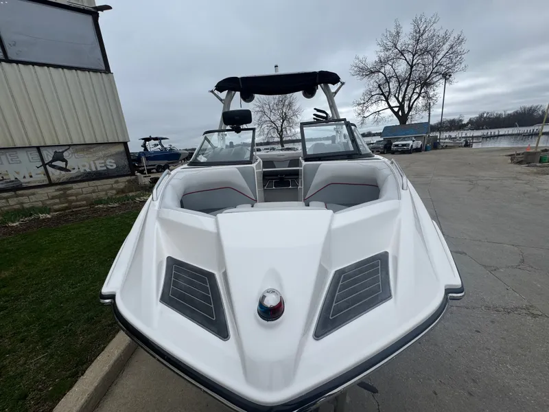Slide: The Image of 2017 Moomba Mondo boat at dock under gray sky. - 8
