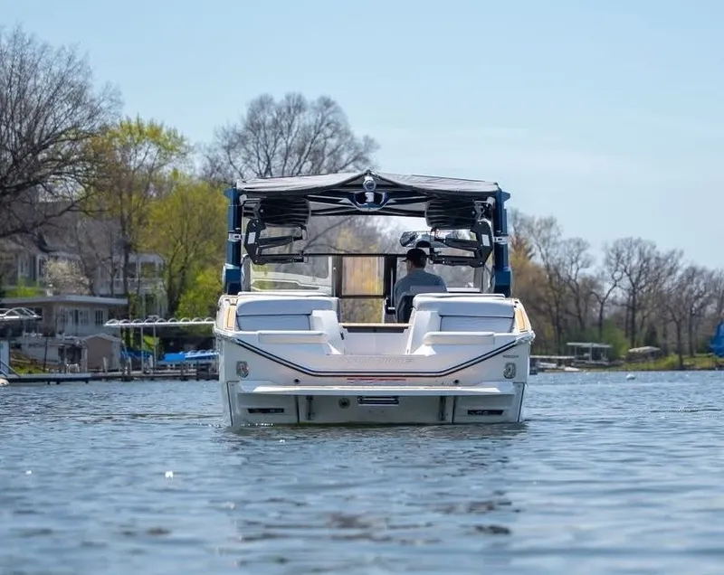 Slide: The Image of 2026 Nautique G25 boat on a tranquil lake. - 5