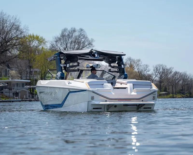 Slide: The Image of 2026 Nautique G25 boat on a serene lake. - 6