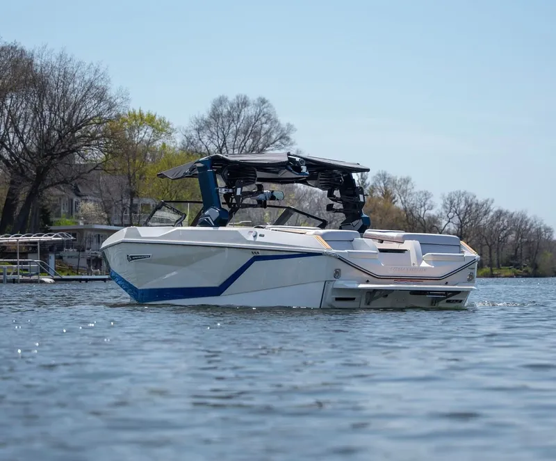 Slide: The Image of 2026 Nautique G25 boat on a serene lake. - 7