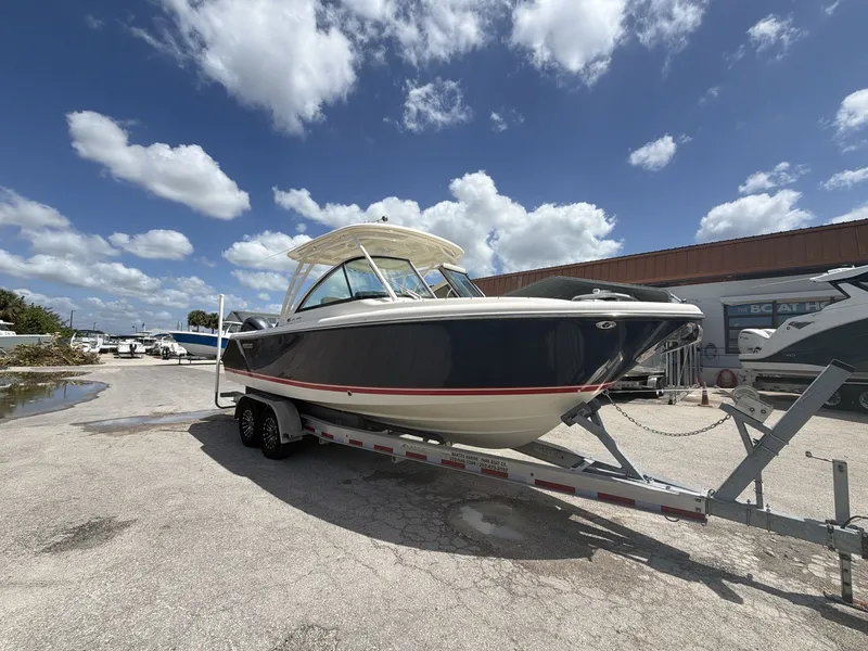 The Image of 2014 Pursuit DC 265 Dual Console boat on trailer. - 1