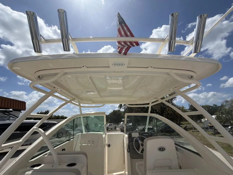 Slide: The Image of 2014 Pursuit DC 265 Dual Console boat with American flag. - 12