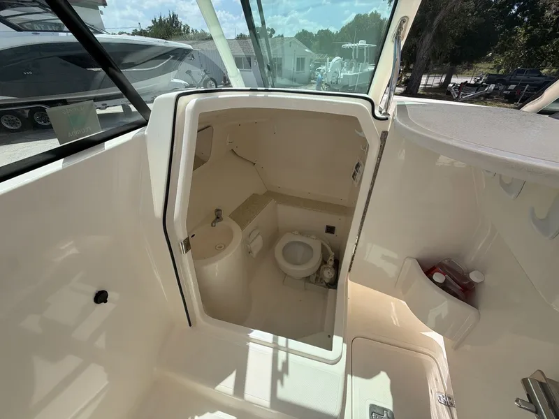 Slide: The Image of Interior view of 2014 Pursuit DC 265 Dual Console with toilet. - 13