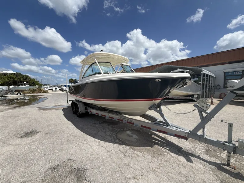 Slide: The Image of 2014 Pursuit DC 265 Dual Console boat on trailer under blue sky. - 15