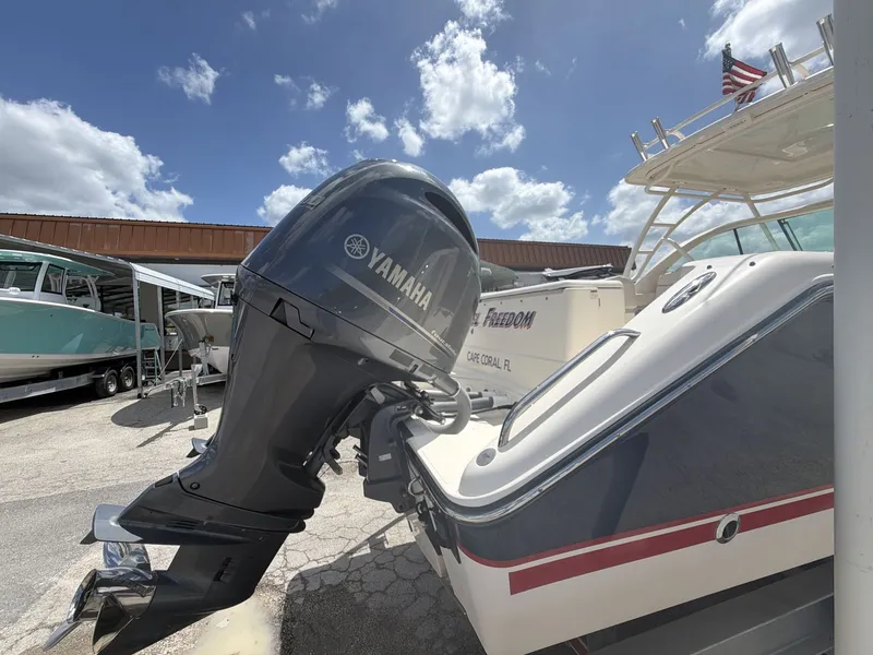 Slide: The Image of 2014 Pursuit DC 265 Dual Console with Yamaha engine outdoors. - 17