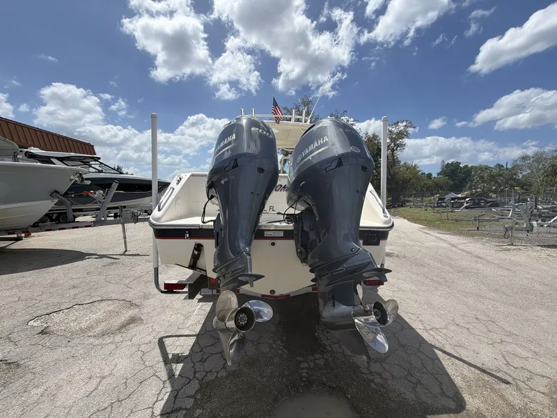 Slide: The Image of 2014 Pursuit DC 265 Dual Console with Yamaha engines outdoors. - 18