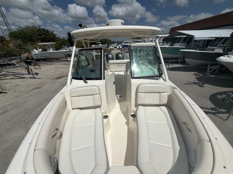 Slide: The Image of 2014 Pursuit DC 265 Dual Console boat outdoors in sunny weather. - 19