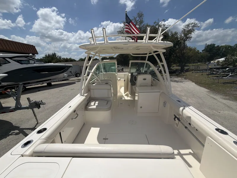 Slide: The Image of 2014 Pursuit DC 265 Dual Console boat outdoors under sunny skies. - 20
