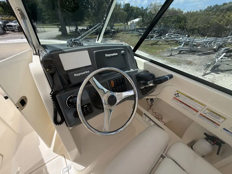 Slide: The Image of Helm of a 2014 Pursuit DC 265 Dual Console boat. - 21