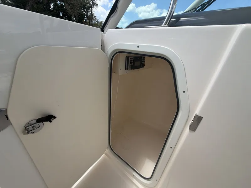 Slide: The Image of Open cabin door of a 2014 Pursuit DC 265 Dual Console. - 22