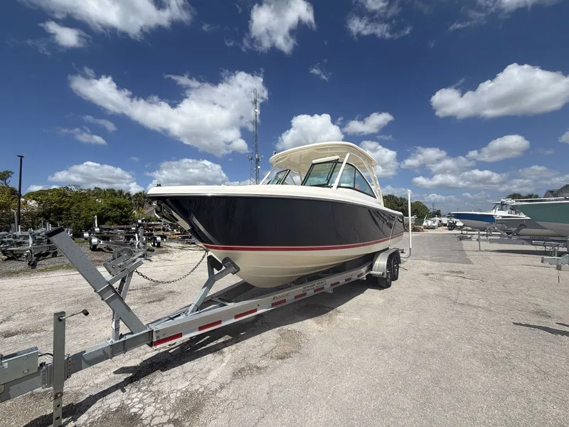 Slide: The Image of 2014 Pursuit DC 265 Dual Console on trailer under blue sky. - 3