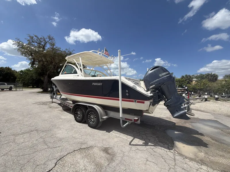 Slide: The Image of 2014 Pursuit DC 265 Dual Console boat on trailer, sunny day. - 5