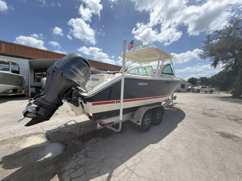 Slide: The Image of 2014 Pursuit DC 265 Dual Console boat on trailer, sunny day. - 7