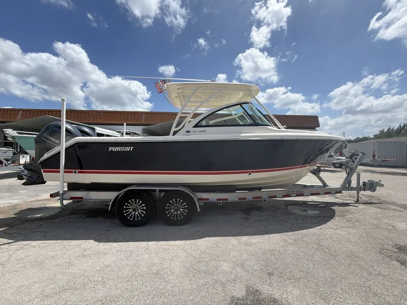 Slide: The Image of 2014 Pursuit DC 265 Dual Console boat on trailer. - 8