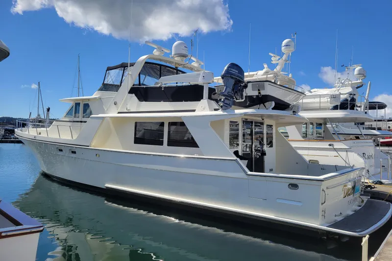 The Image of 1998 Tollycraft 65 Pilothouse yacht docked in marina under blue sky. - 0