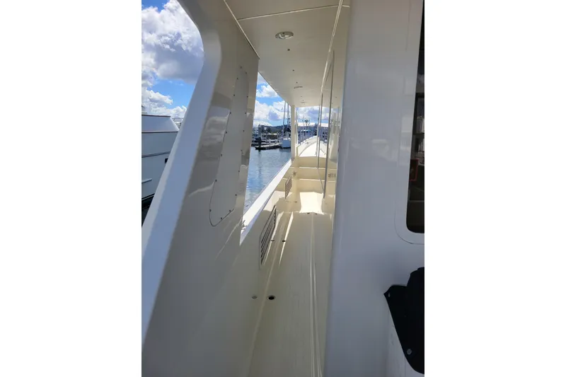 Slide: The Image of Side deck view of a 1998 Tollycraft 65 Pilothouse yacht under a sunny sky. - 15