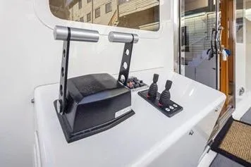 Slide: The Image of 1998 Tollycraft 65 Pilothouse yacht controls with dual levers and joystick. - 16