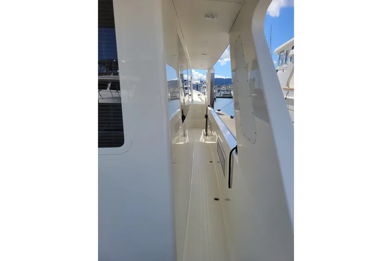 Slide: The Image of Side deck view of 1998 Tollycraft 65 Pilothouse yacht in marina. - 17