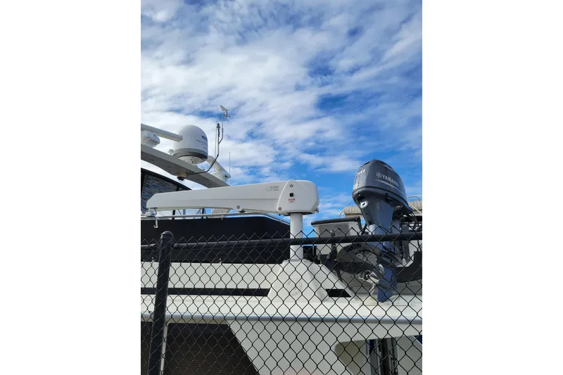 Slide: The Image of 1998 Tollycraft 65 Pilothouse yacht with Yamaha motor, under a blue sky. - 18