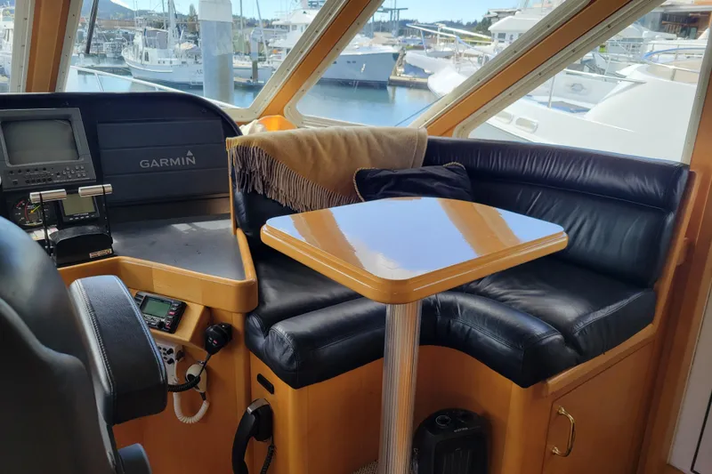 Slide: The Image of 1998 Tollycraft 65 Pilothouse interior with leather seating and navigation equipment. - 20