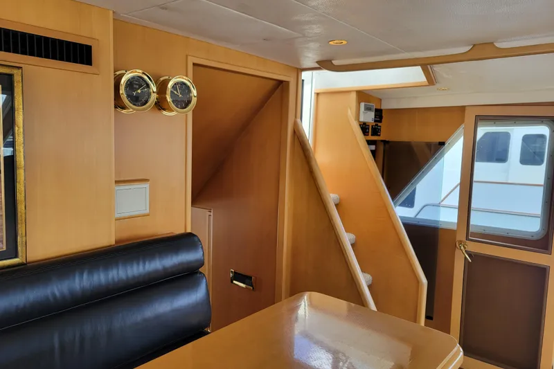 Slide: The Image of Interior of 1998 Tollycraft 65 Pilothouse with wooden paneling and nautical instruments. - 22