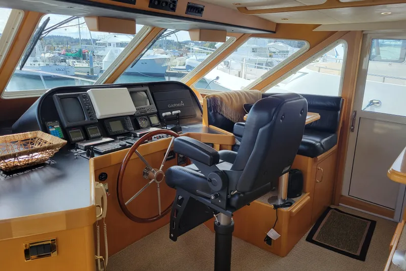 Slide: The Image of 1998 Tollycraft 65 Pilothouse interior with navigation equipment and captain's chair. - 23