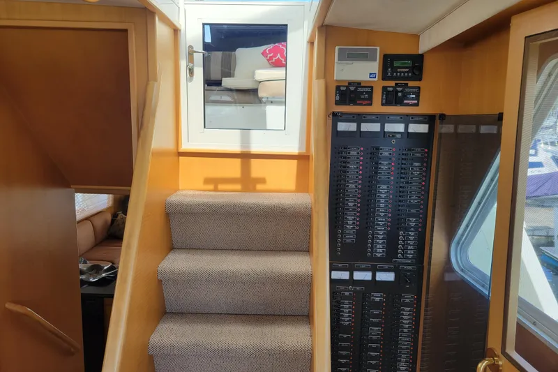 Slide: The Image of Interior of 1998 Tollycraft 65 Pilothouse showing stairs and control panel. - 25