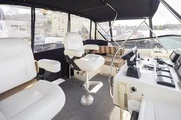 Slide: The Image of 1998 Tollycraft 65 Pilothouse interior with helm, seating, and navigation equipment. - 26