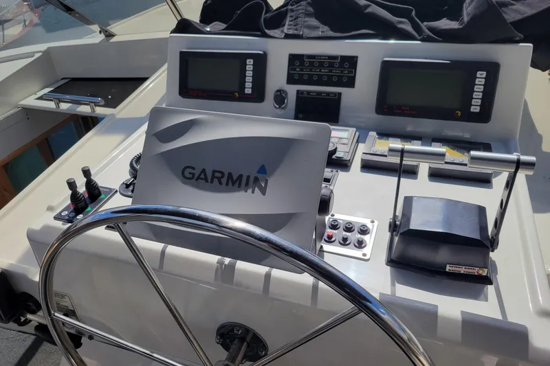 Slide: The Image of 1998 Tollycraft 65 Pilothouse helm with Garmin navigation and control systems. - 30