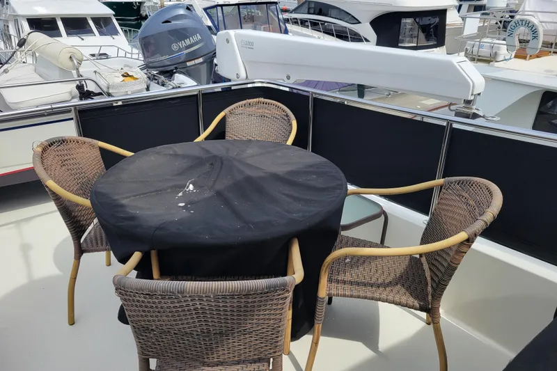 Slide: The Image of Covered table on 1998 Tollycraft 65 Pilothouse yacht deck. - 33