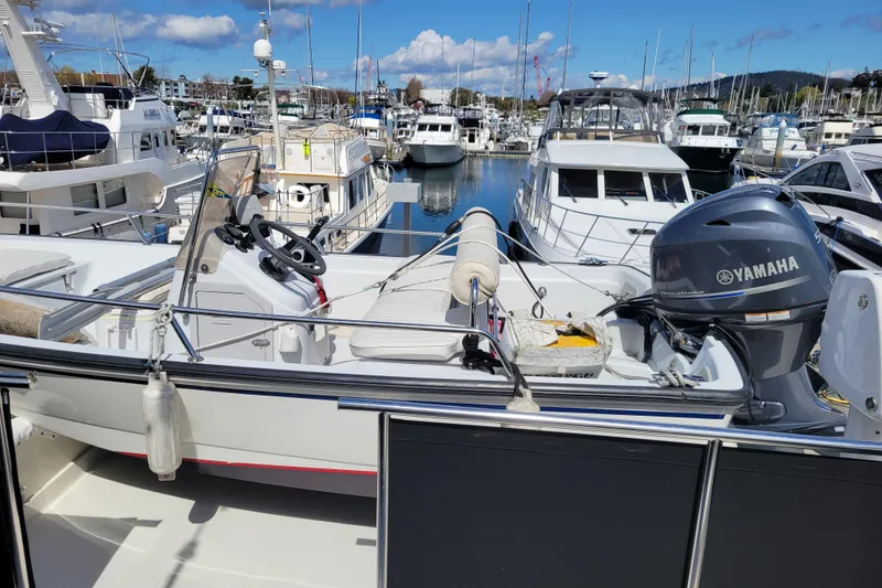 Slide: The Image of 1998 Tollycraft 65 Pilothouse yacht docked in marina with Yamaha outboard motor. - 34