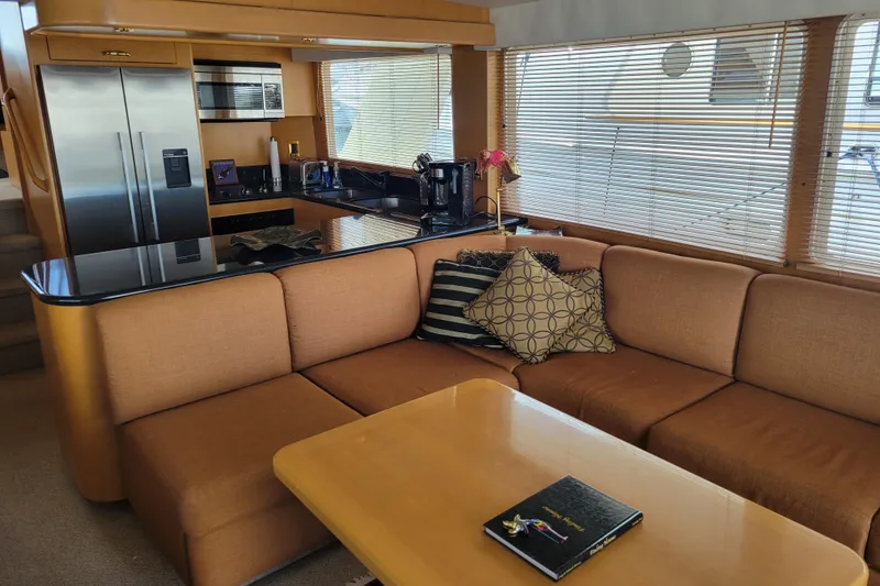 Slide: The Image of Luxurious interior of a 1998 Tollycraft 65 Pilothouse yacht with modern kitchen and cozy seating. - 36