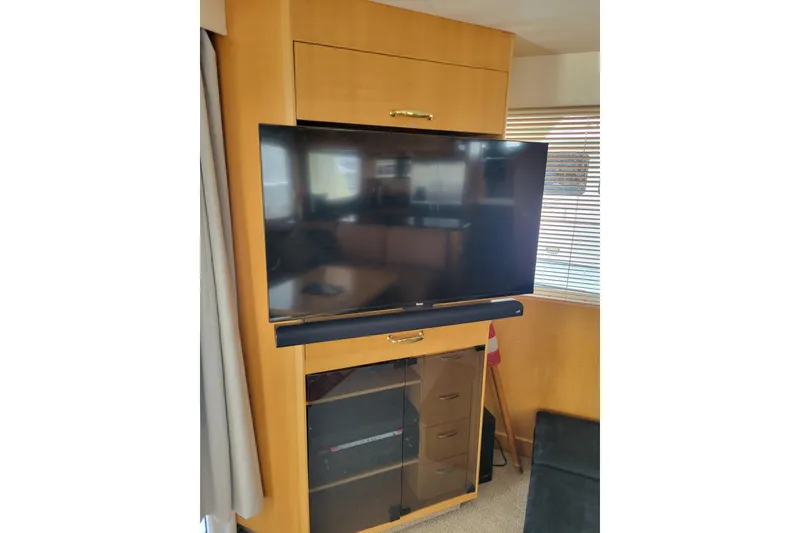 Slide: The Image of Entertainment center with TV and soundbar in 1998 Tollycraft 65 Pilothouse yacht interior. - 41