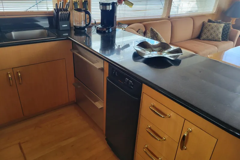 Slide: The Image of Kitchen area of a 1998 Tollycraft 65 Pilothouse yacht with modern appliances. - 43