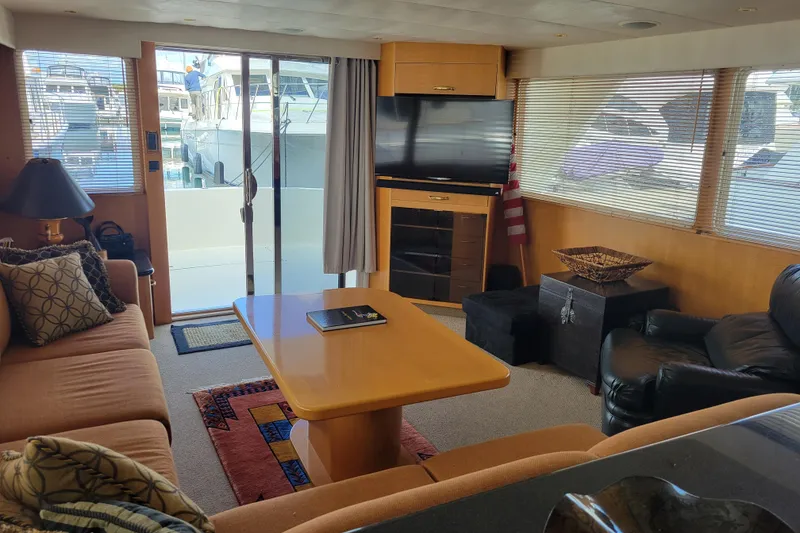 Slide: The Image of Luxurious interior of a 1998 Tollycraft 65 Pilothouse yacht with cozy seating and large windows. - 46