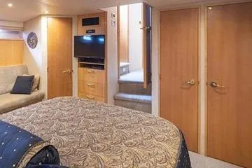 Slide: The Image of Luxurious interior of 1998 Tollycraft 65 Pilothouse yacht with elegant bedroom and TV. - 49