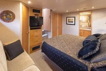 Slide: The Image of Luxurious bedroom interior of 1998 Tollycraft 65 Pilothouse yacht with elegant decor. - 50