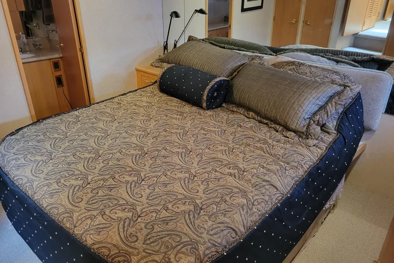 Slide: The Image of Luxurious bedroom interior of 1998 Tollycraft 65 Pilothouse yacht with elegant bedding. - 52