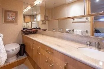 Slide: The Image of Luxurious bathroom in a 1998 Tollycraft 65 Pilothouse yacht with elegant fixtures and ample storage. - 53