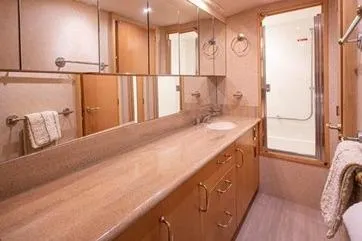 Slide: The Image of Luxurious bathroom in 1998 Tollycraft 65 Pilothouse yacht with elegant fixtures and ample storage. - 54