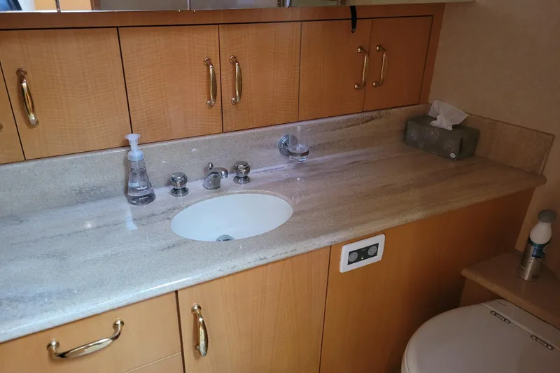 Slide: The Image of Bathroom vanity in 1998 Tollycraft 65 Pilothouse yacht with sink and wooden cabinetry. - 58