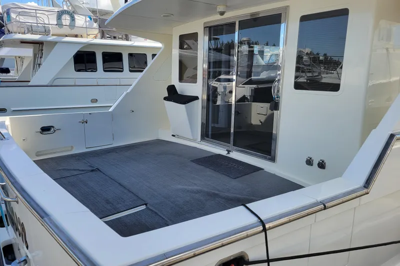 Slide: The Image of 1998 Tollycraft 65 Pilothouse yacht with spacious deck and sliding glass doors. - 6