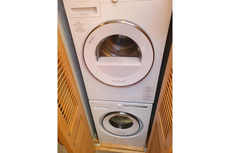 Slide: The Image of Stacked washer and dryer in 1998 Tollycraft 65 pilothouse yacht laundry area. - 60