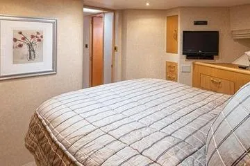 Slide: The Image of Luxurious bedroom interior of 1998 Tollycraft 65 Pilothouse yacht with modern amenities. - 62